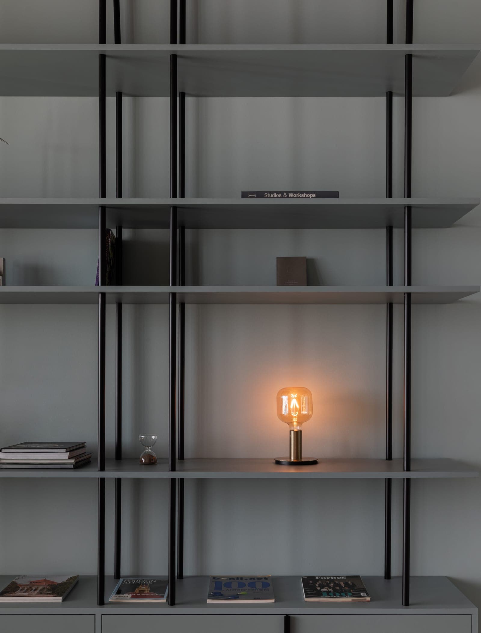 A lit bulb on a shelf