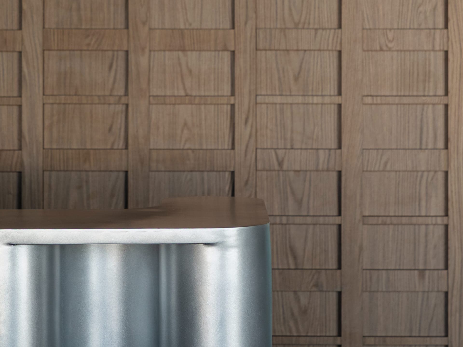 Oak slatted cladding meeting the steel reception desk, ADREM Offices