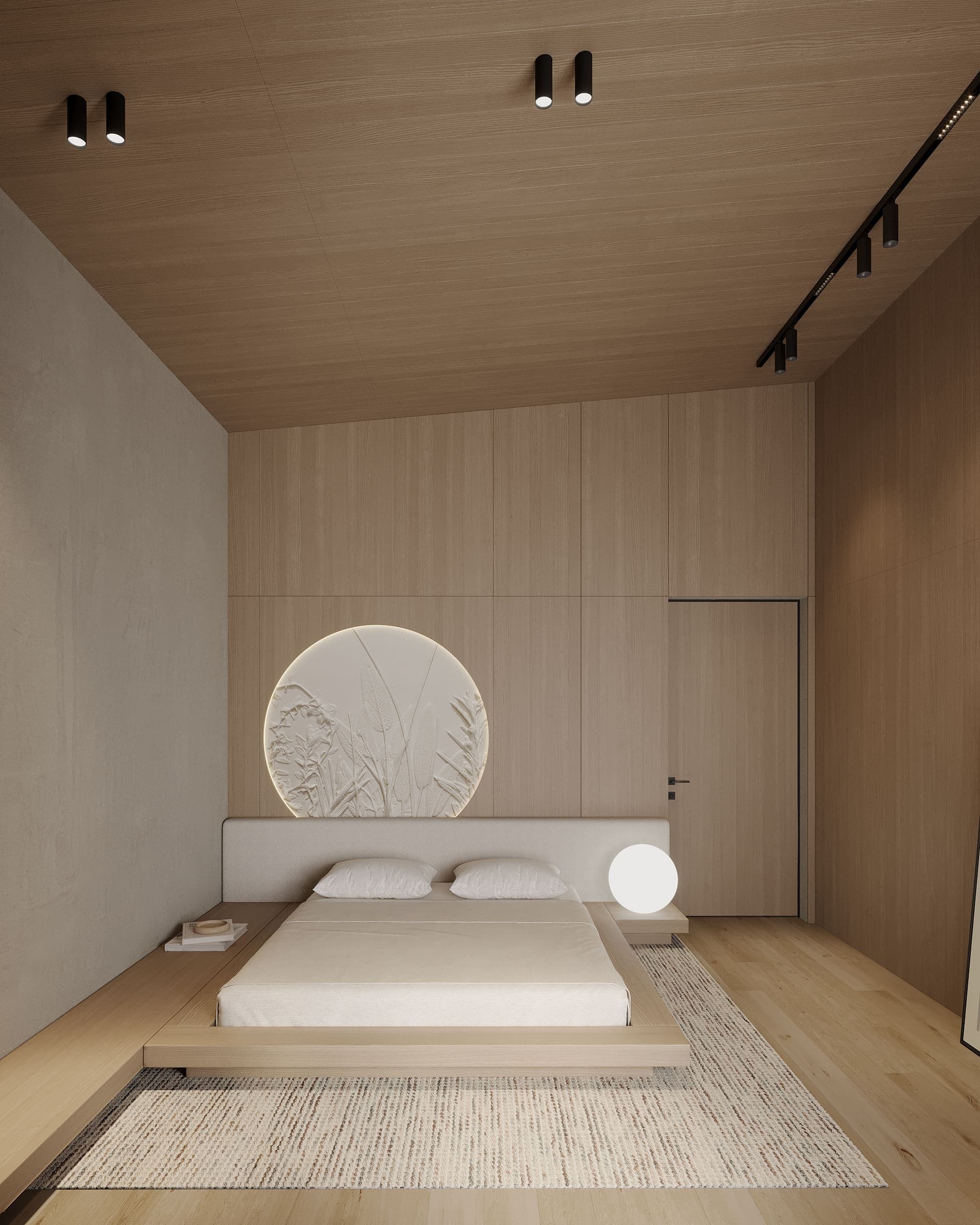 Attic bedroom with a low platform bed and a round plaster artwork